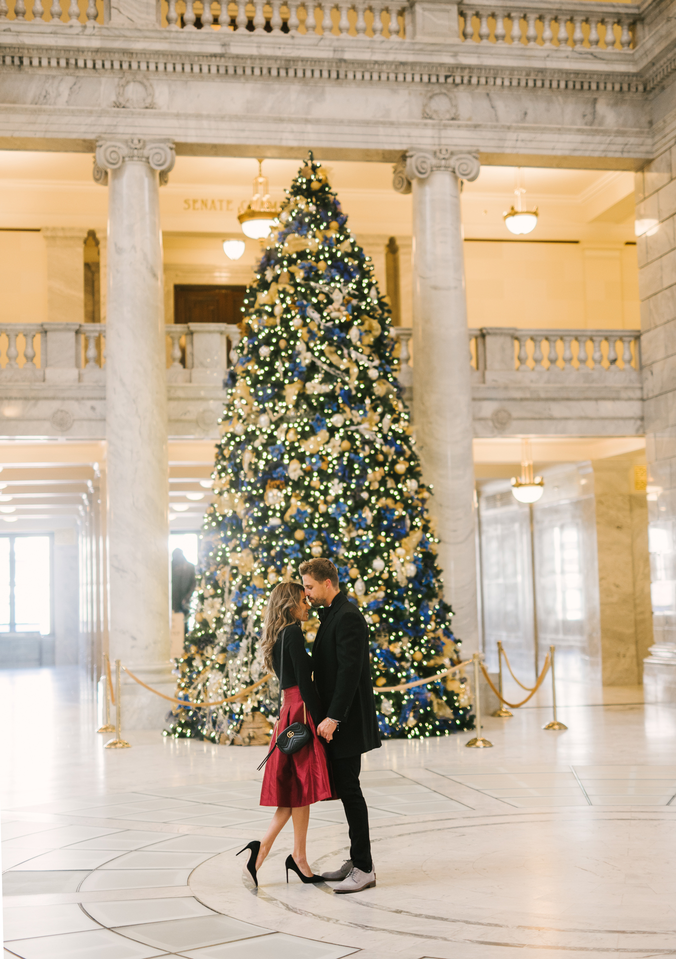 couple by christmas tree