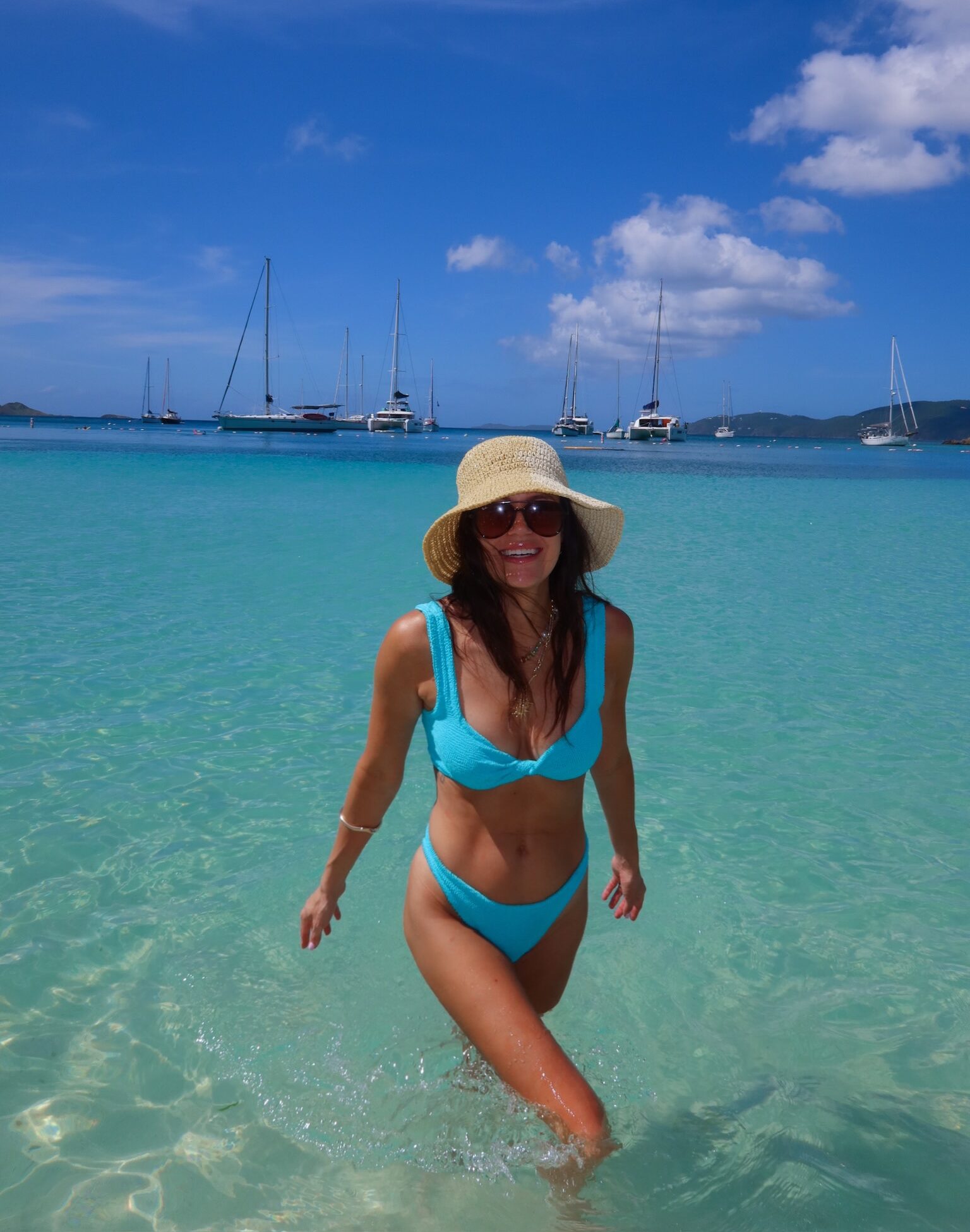 Christine Andrew in blue bikini swimsuit at the beach