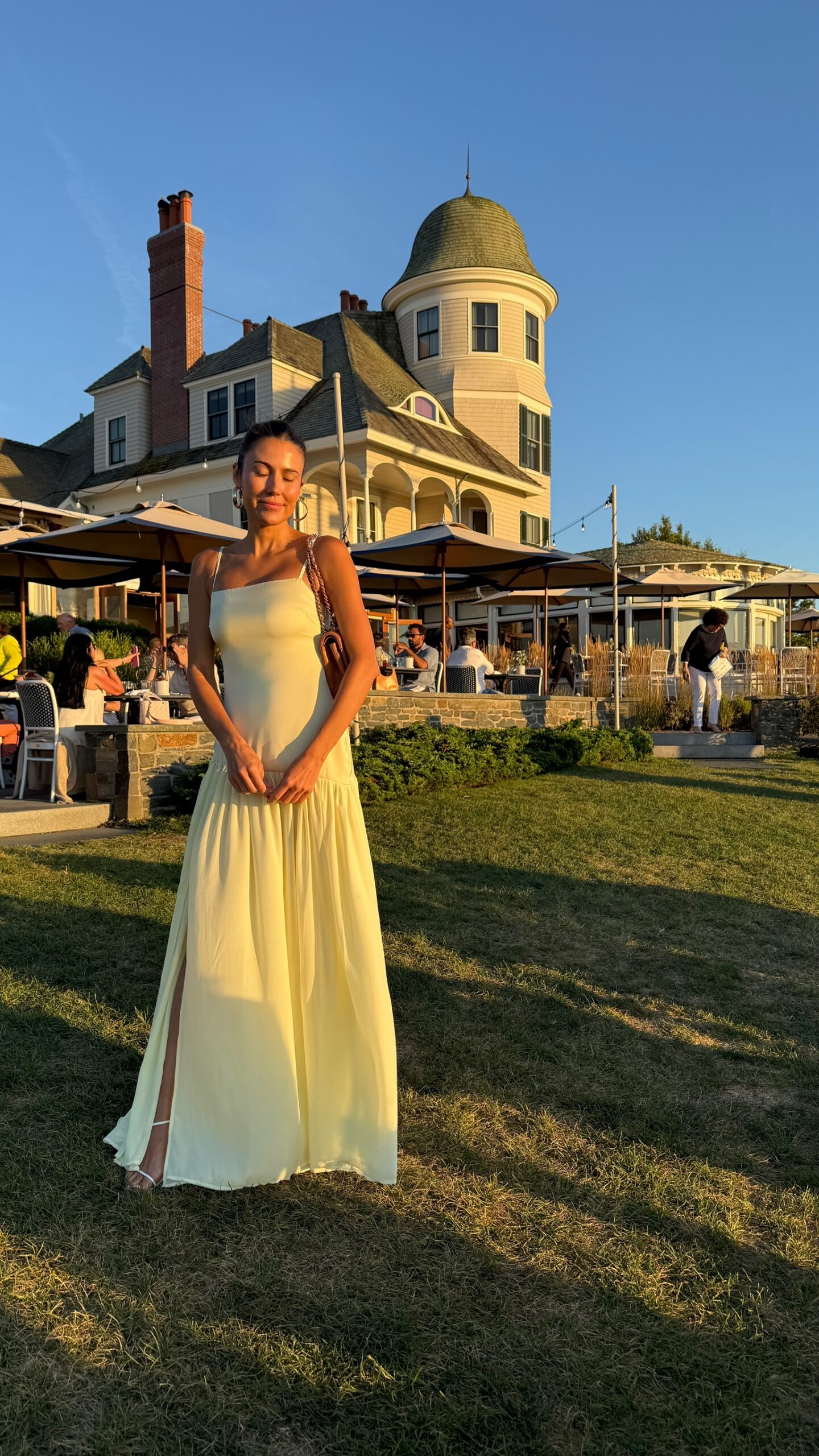 Christine Andrew in a butter yellow wedding guest dress